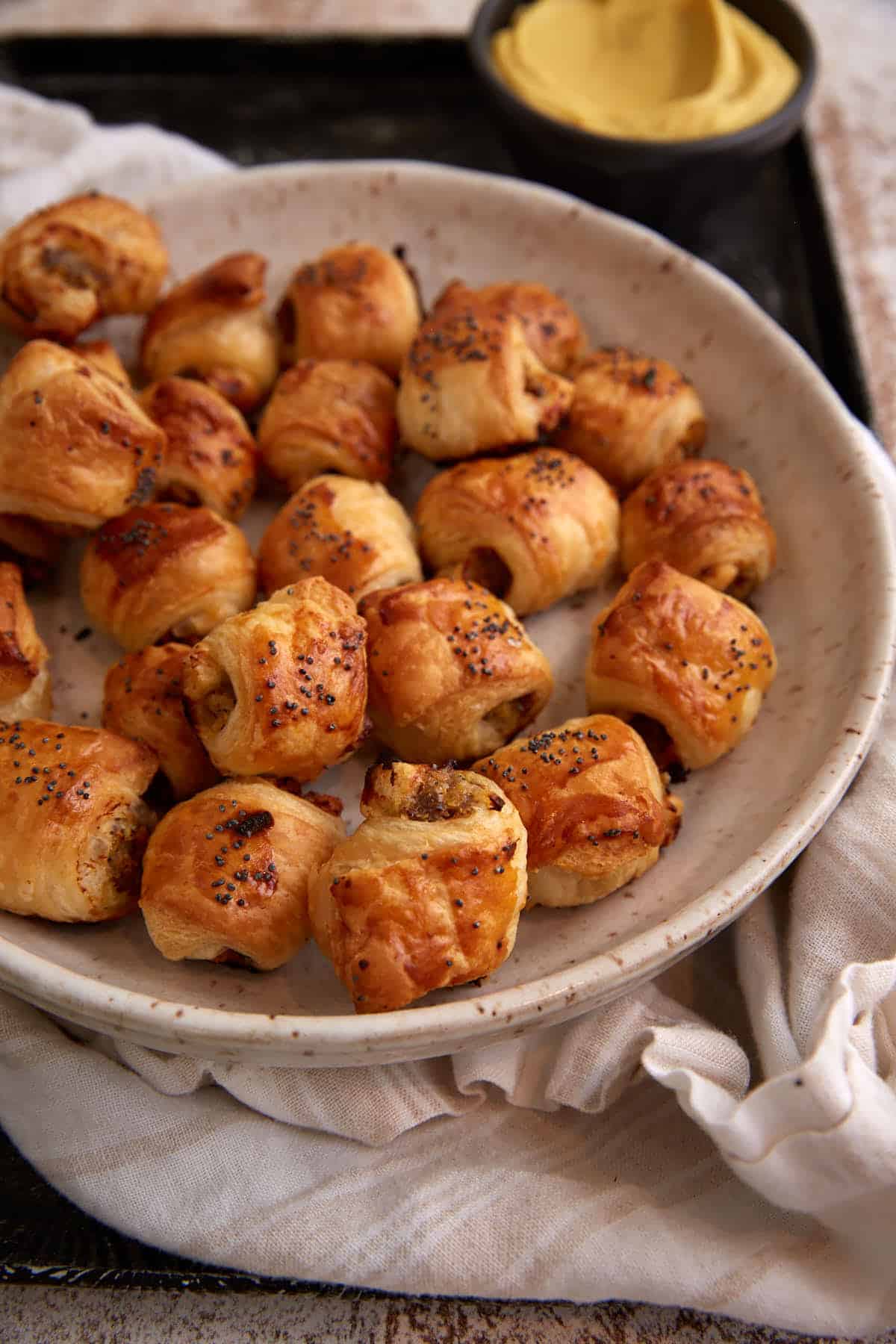 A platter of puff pastry rolls.