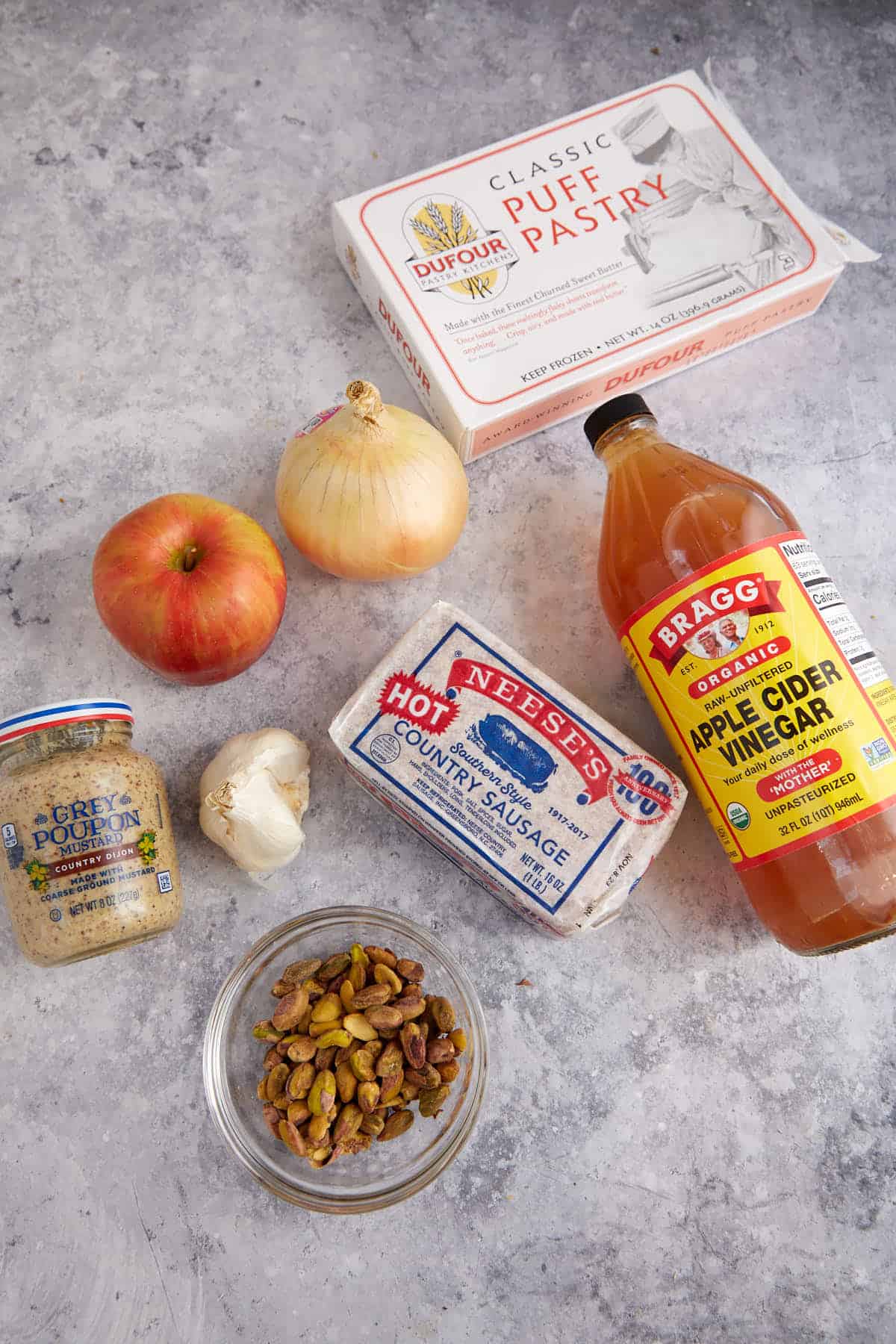 The ingredients for puff pastry apple sausage rolls.