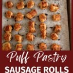 Cooked apple sausage rolls on a baking sheet.