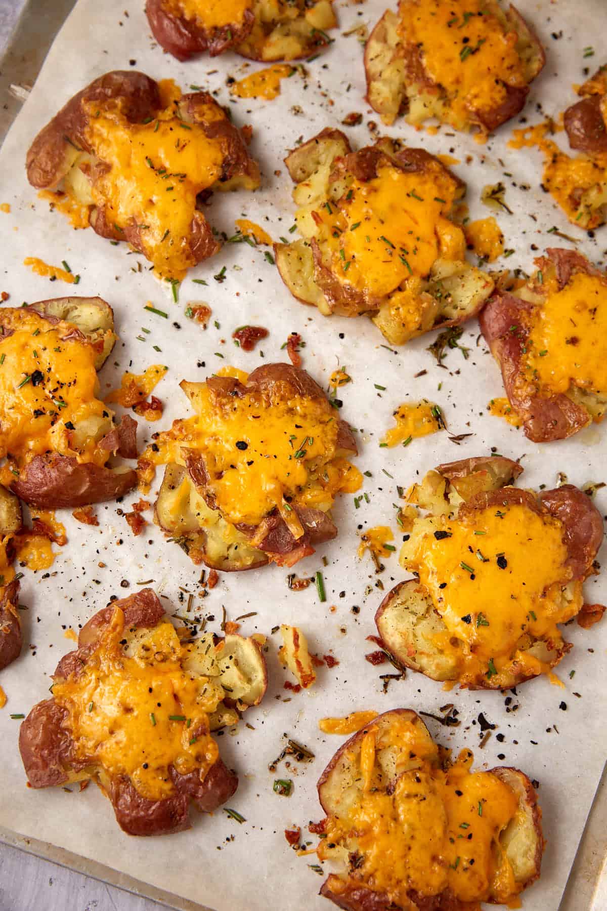 A baking sheet with smashed new potatoes.
