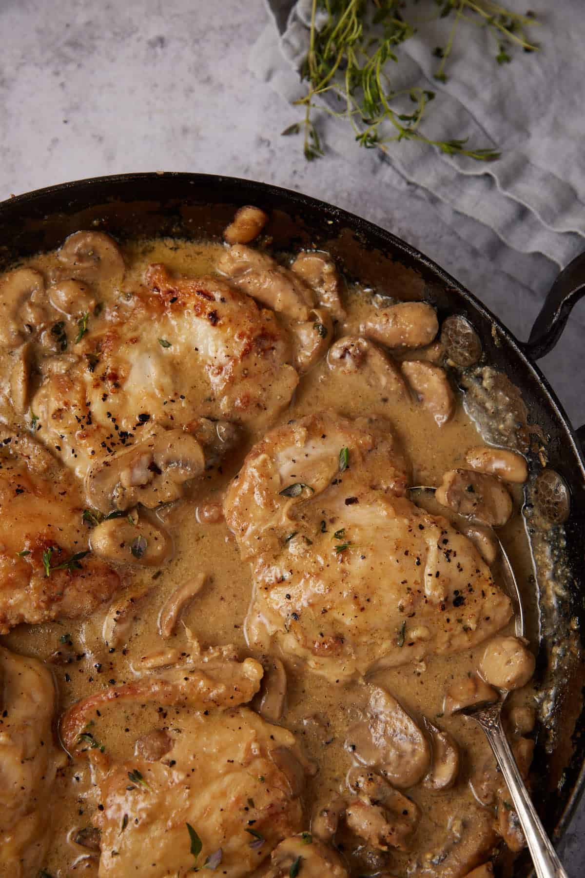 chicken and mushrooms in a skillet.
