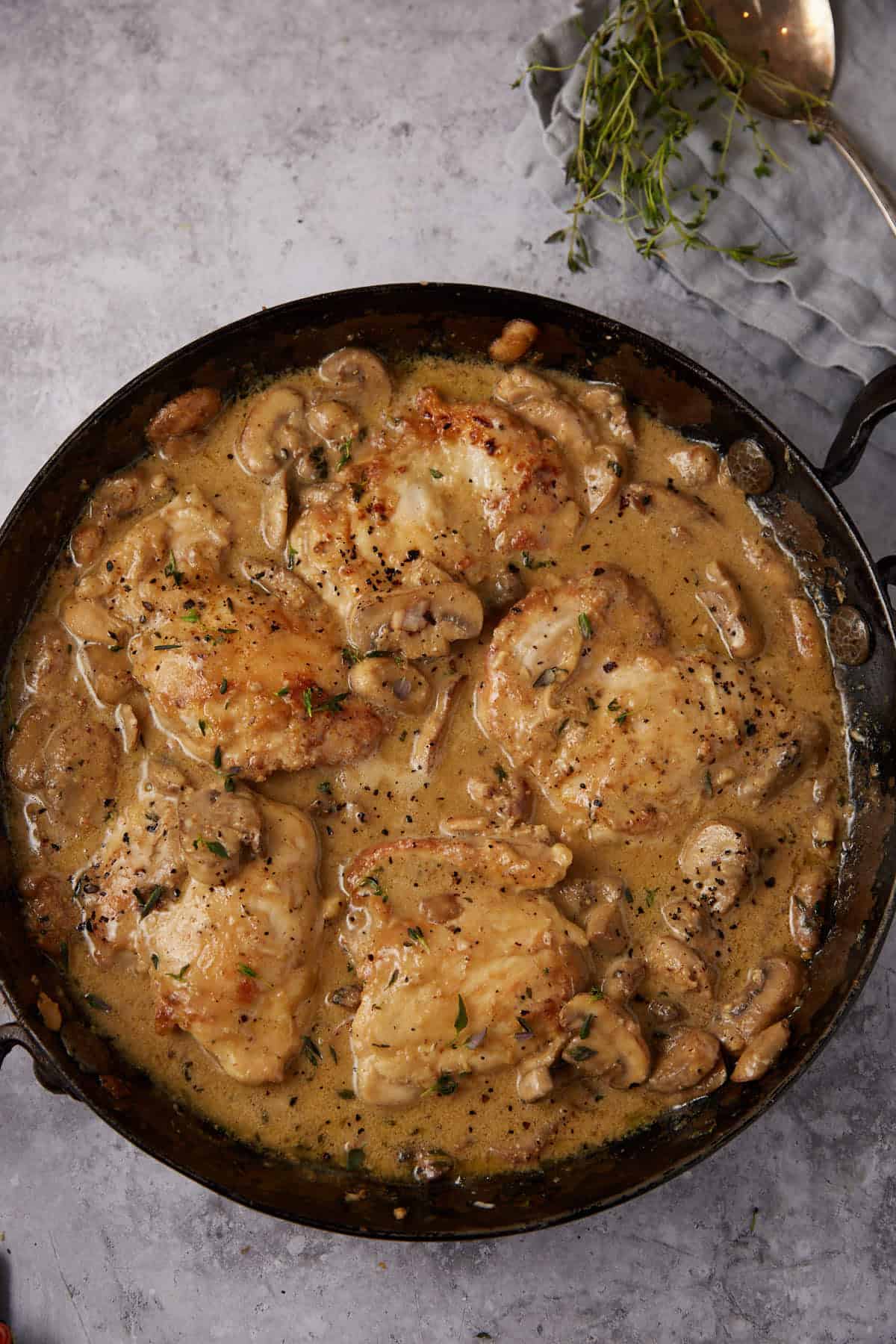 chicken and mushrooms in a skillet.