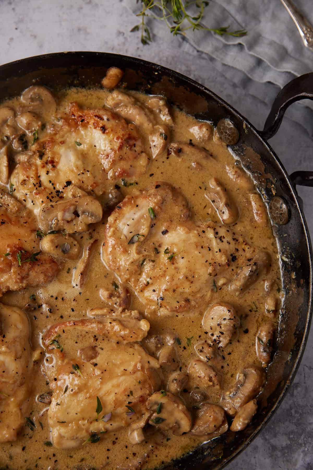 chicken and mushrooms in a skillet.