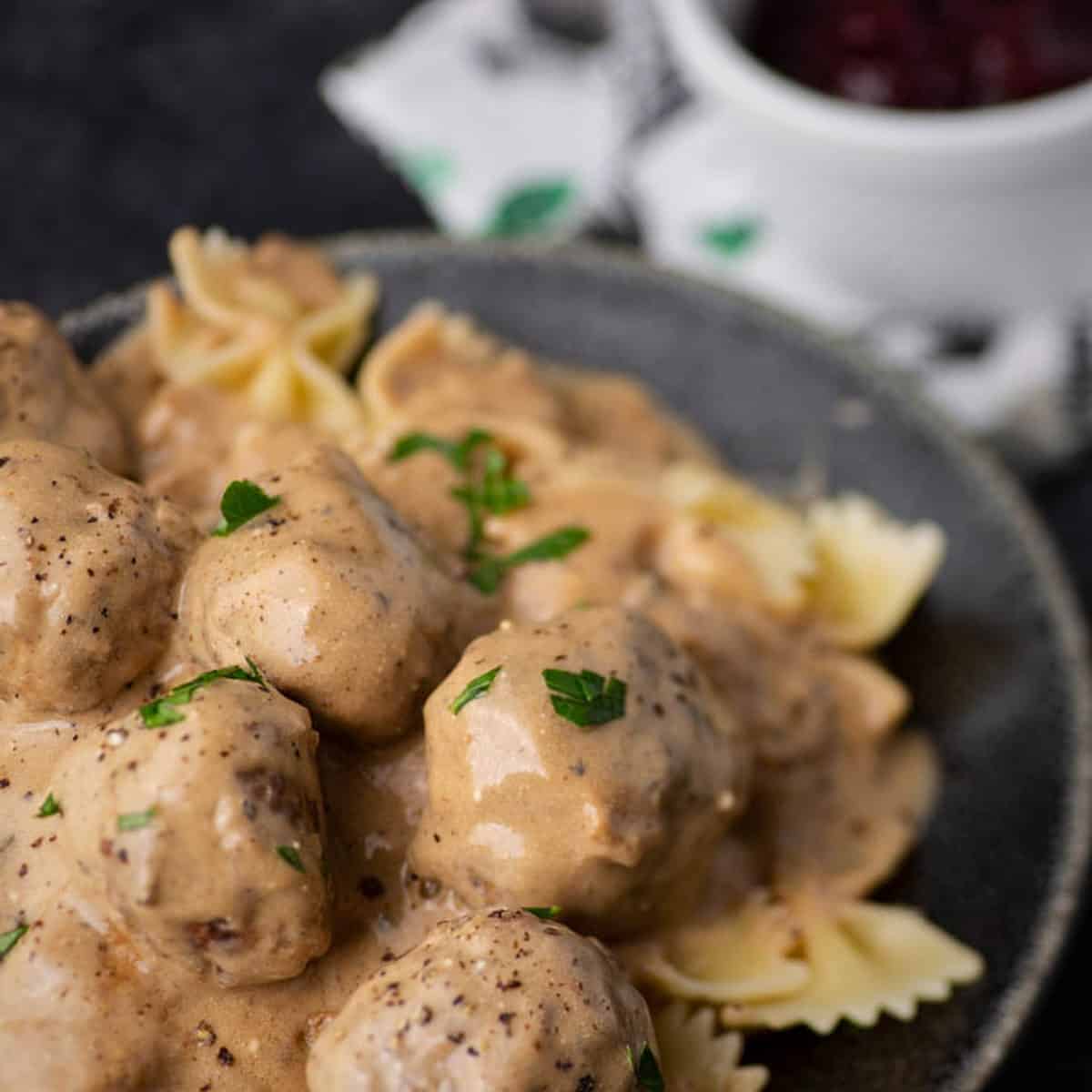 Meatballs in a sour cream sauce on a plate.