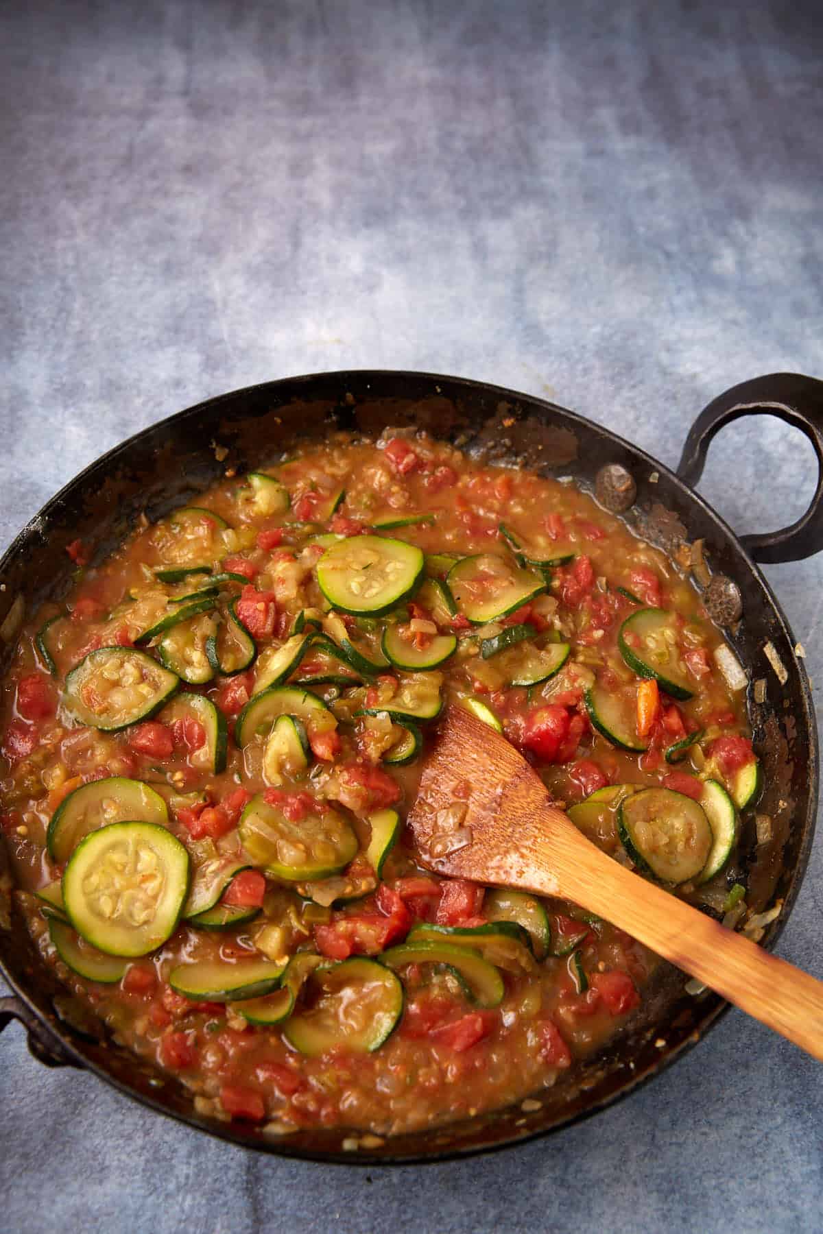 Chicken broth and tomatoes added to the cooked squash.