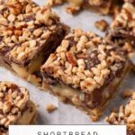 A close-up image of Shortbread Toffee Bars topped with chopped nuts. The bars are arranged on a piece of parchment paper. Text at the top reads "BUTTERANDBAGGAGE.COM," and the text at the bottom reads "SHORTBREAD TOFFEE BARS.