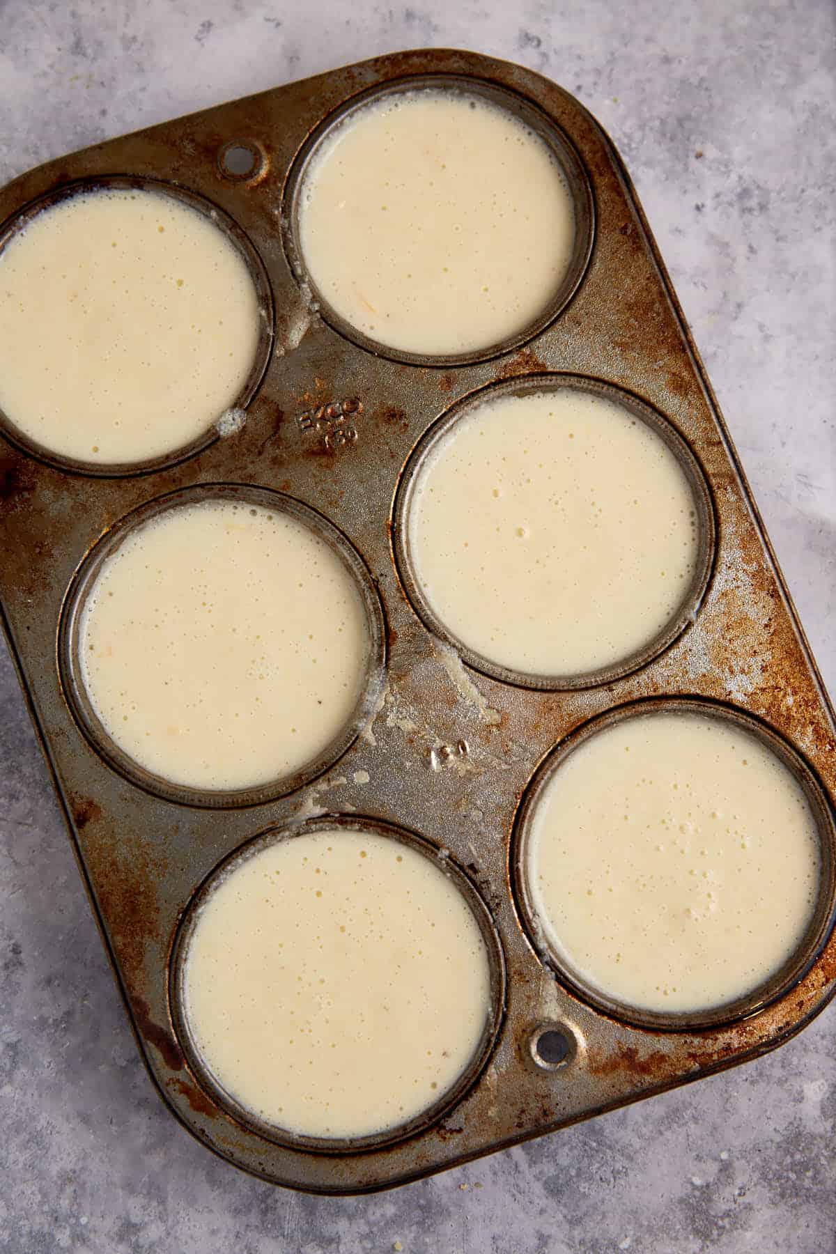 Muffin tins filled with batter.