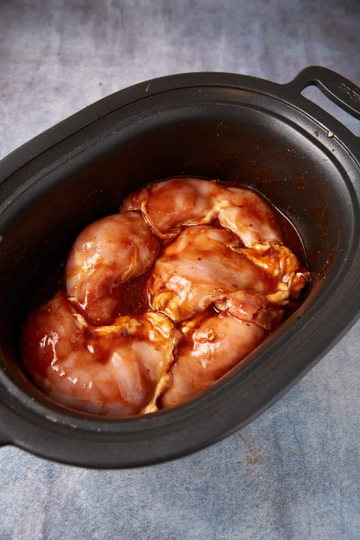 Chicken thighs in a slow cooker.