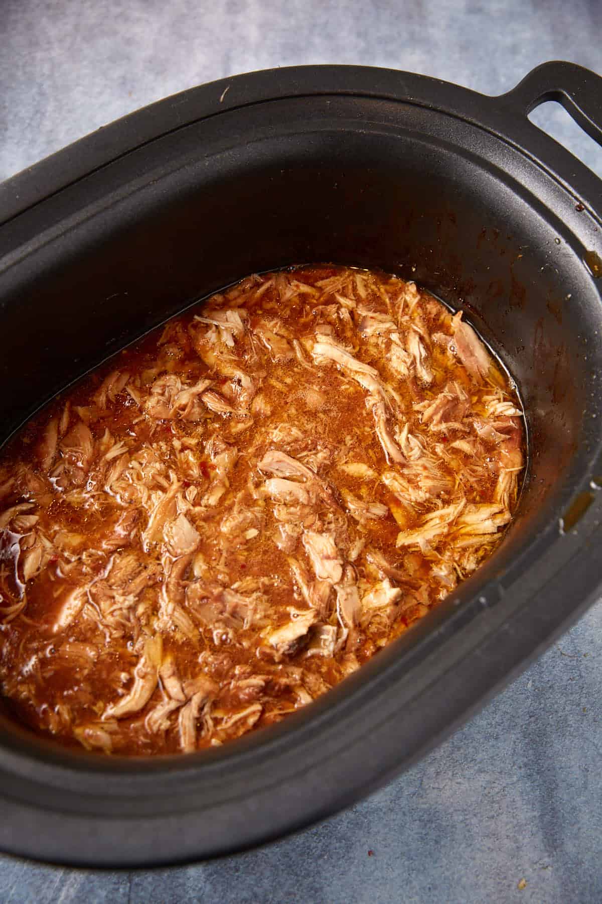 Pulled chicken in bbq sauce in a slow cooker.