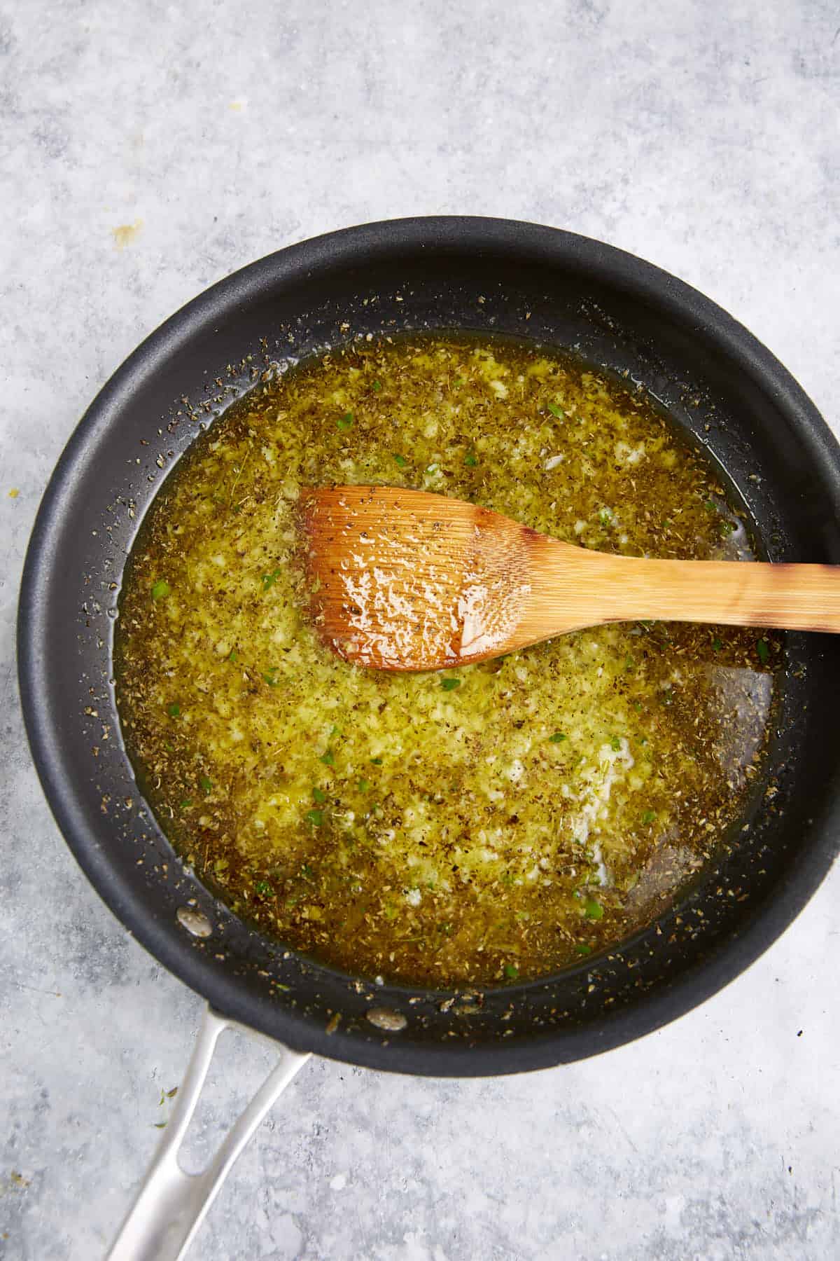 Wine and lemon added to a pan of garlic.