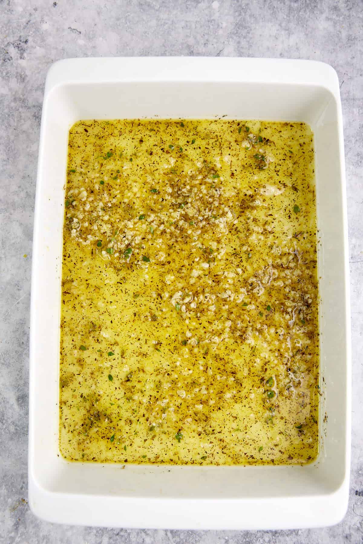 A baking dish with garlic lemon sauce.