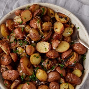 A bowl of oven roasted crispy potatoes and onions
