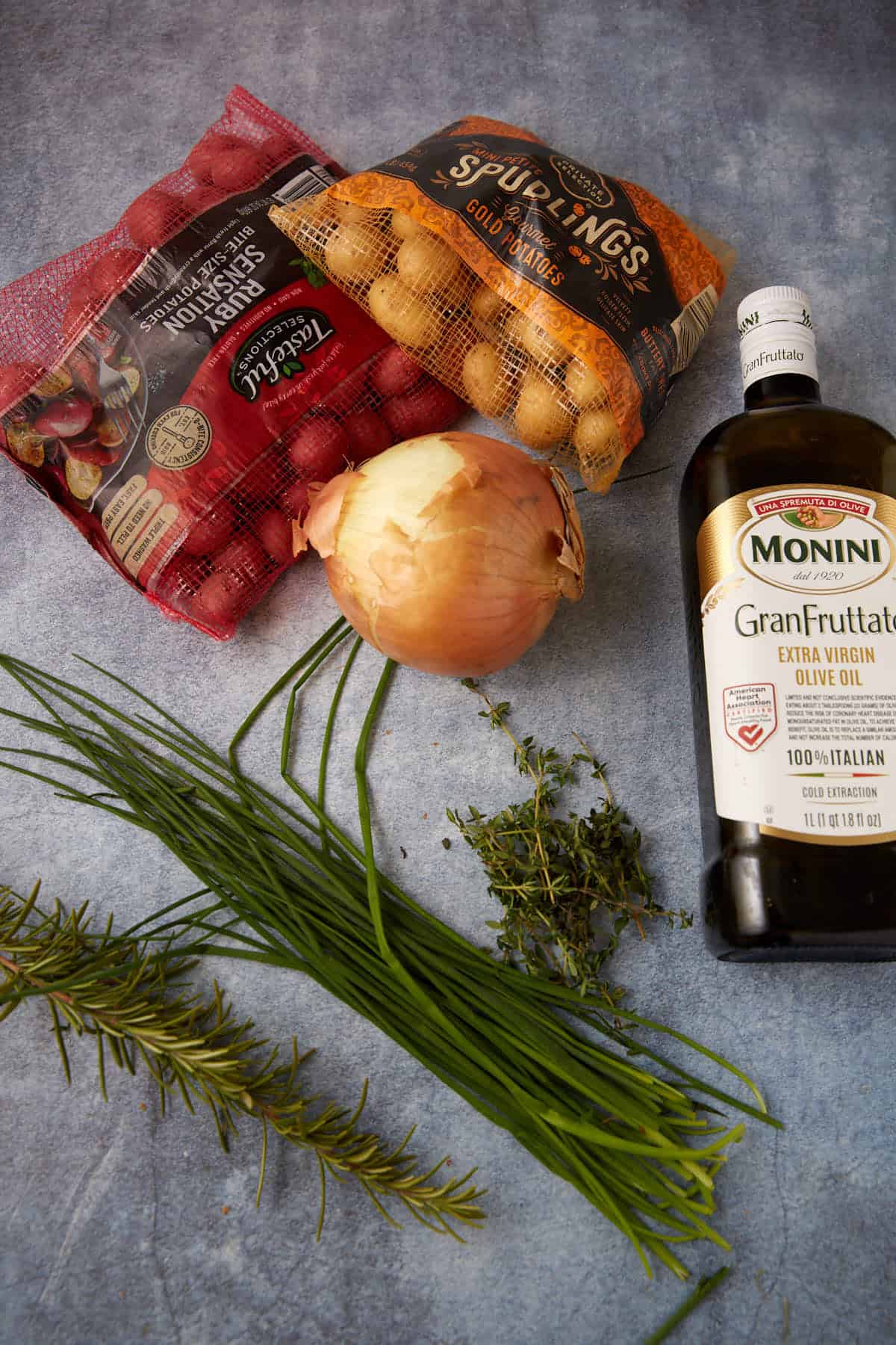 Ingredients for oven roasted potatoes and onions .