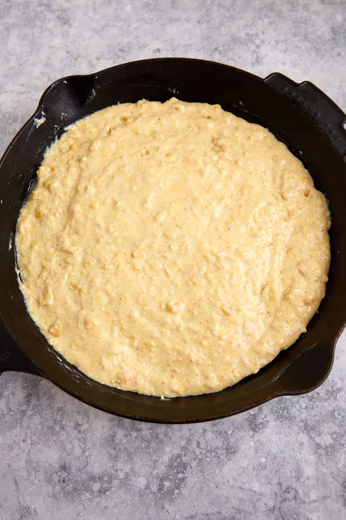 A layer of cornbread in a skillet.