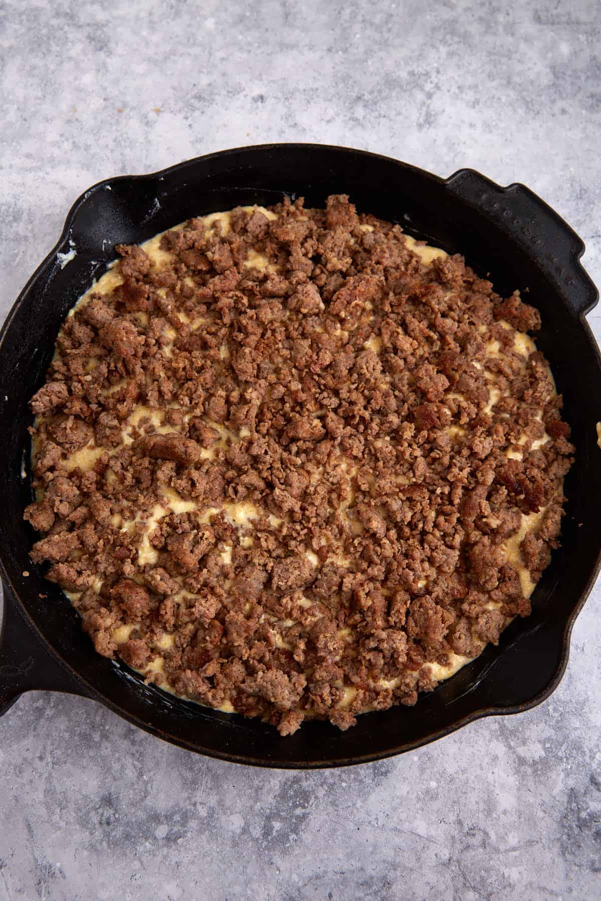 Sausage layered on top of cornbread.