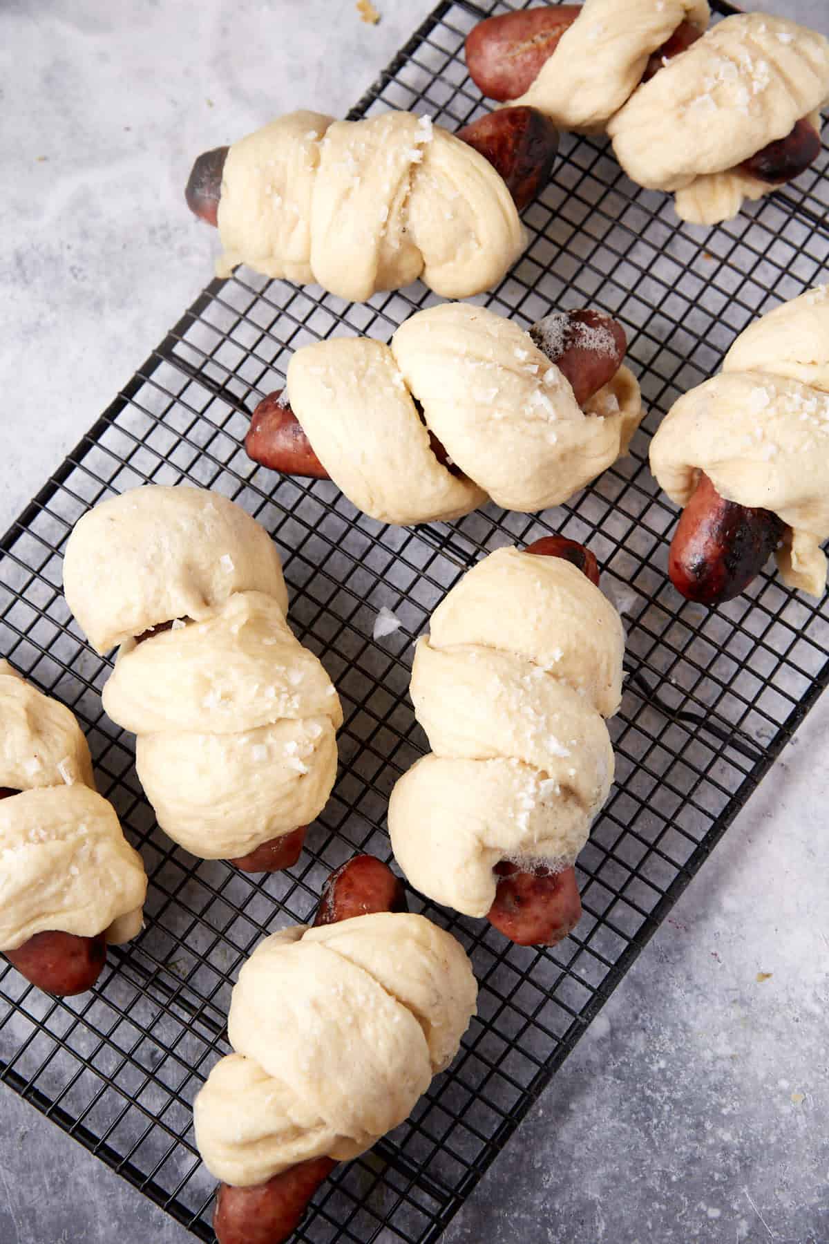 Boiled pretzel dough around bratwurst.