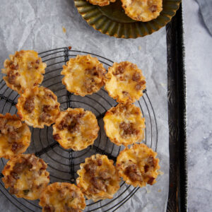 A wire rack with phyllo cups on it.