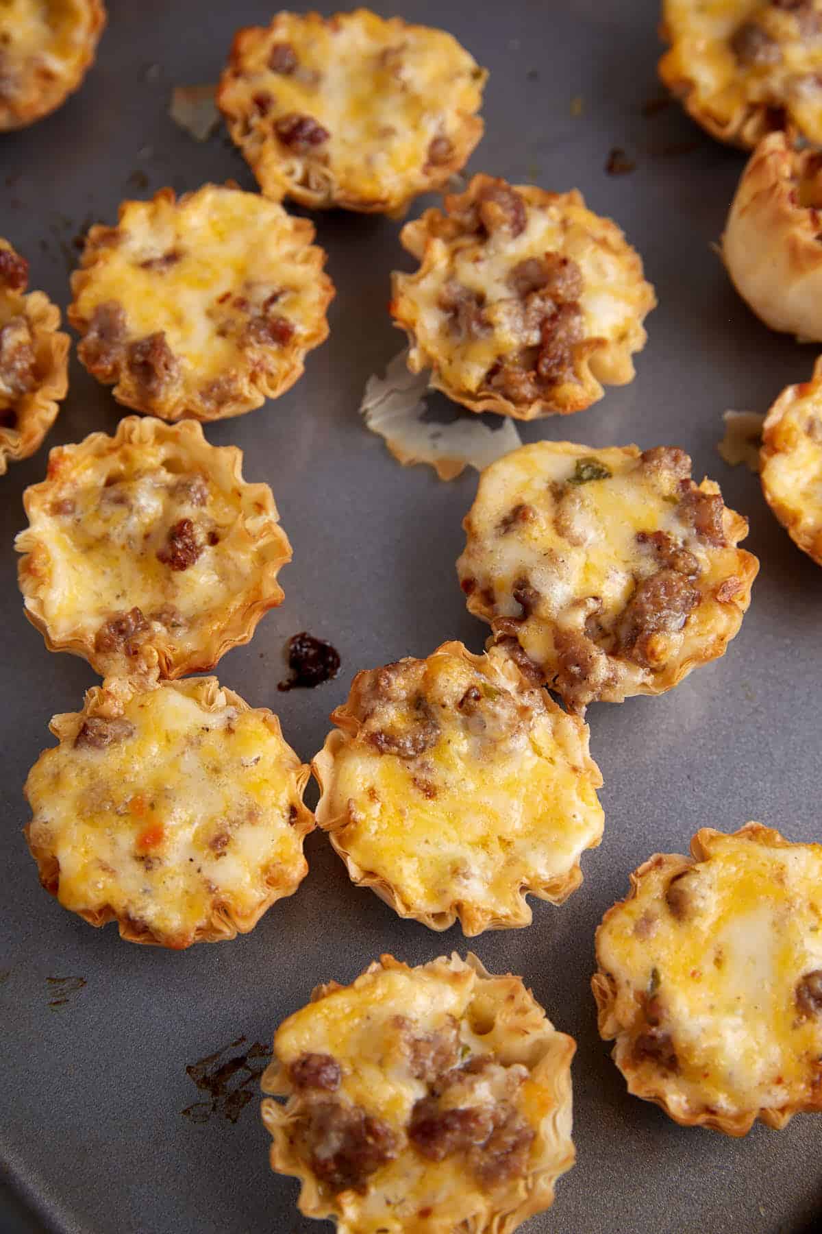 Baked sausage and cheese phyllo cups.