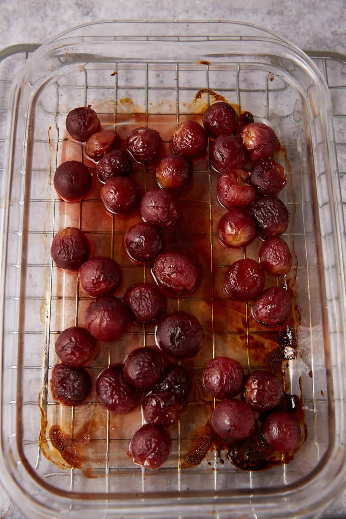 roasted grapes with balsamic vinegar in a baking dish.
