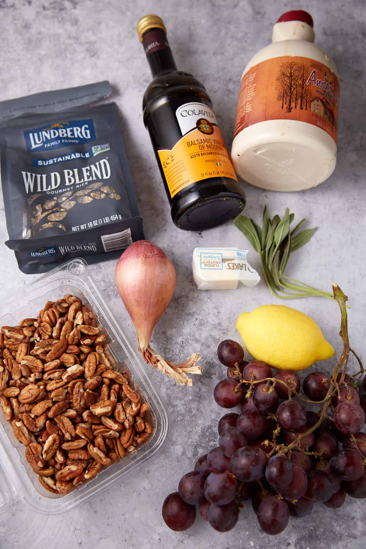 wild rice with grapes ingredients on a gray background.