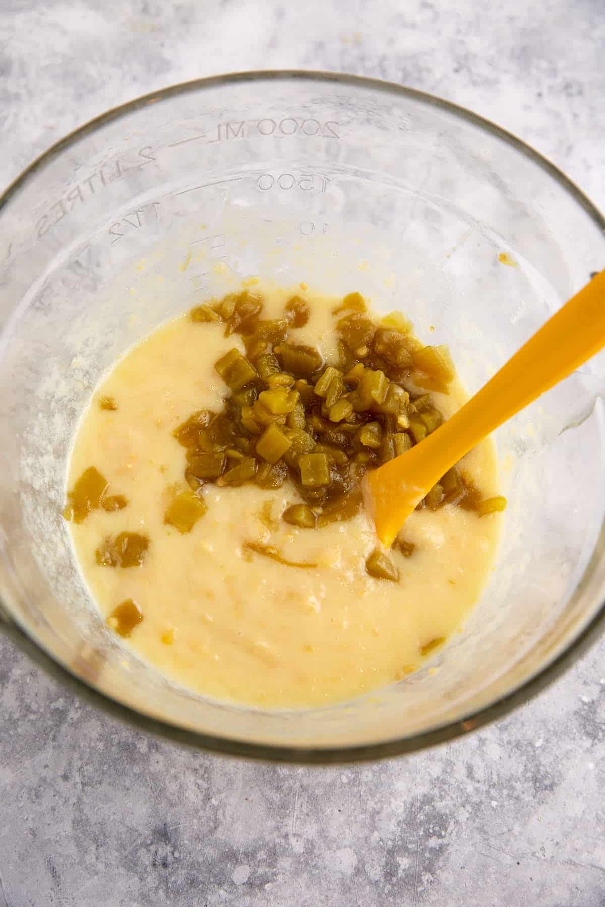 The wet ingredients for cornbread in a bowl.