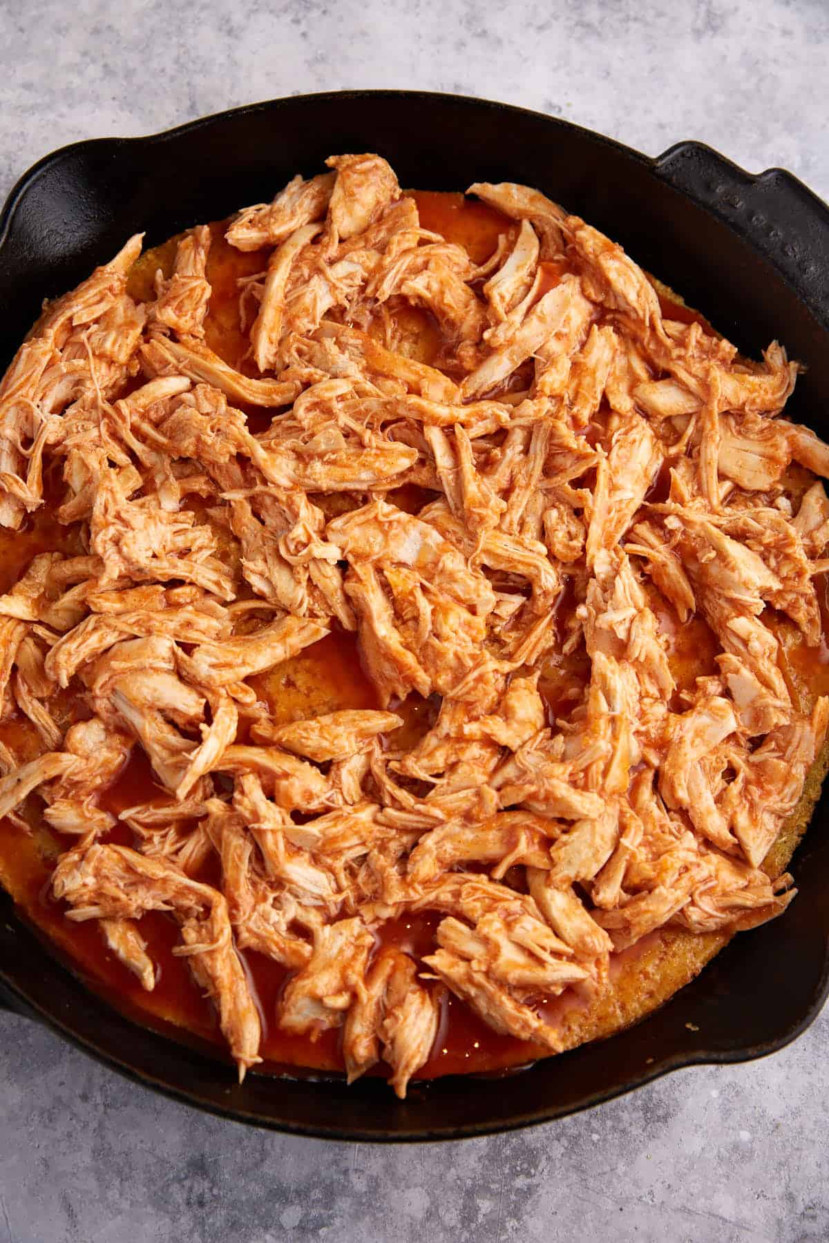 Chicken on top of the cornbread layer.