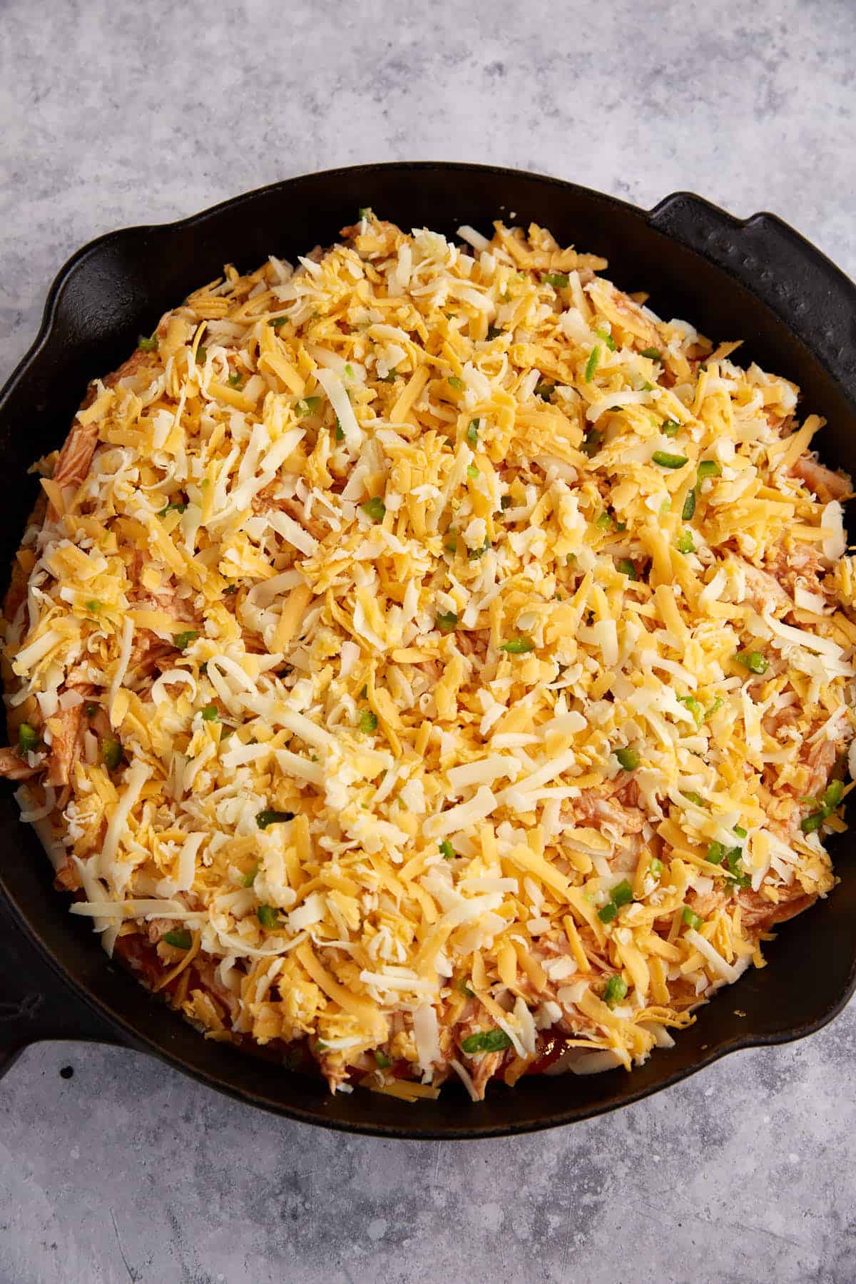 Cheese mixture over the tamale pie in a skillet.