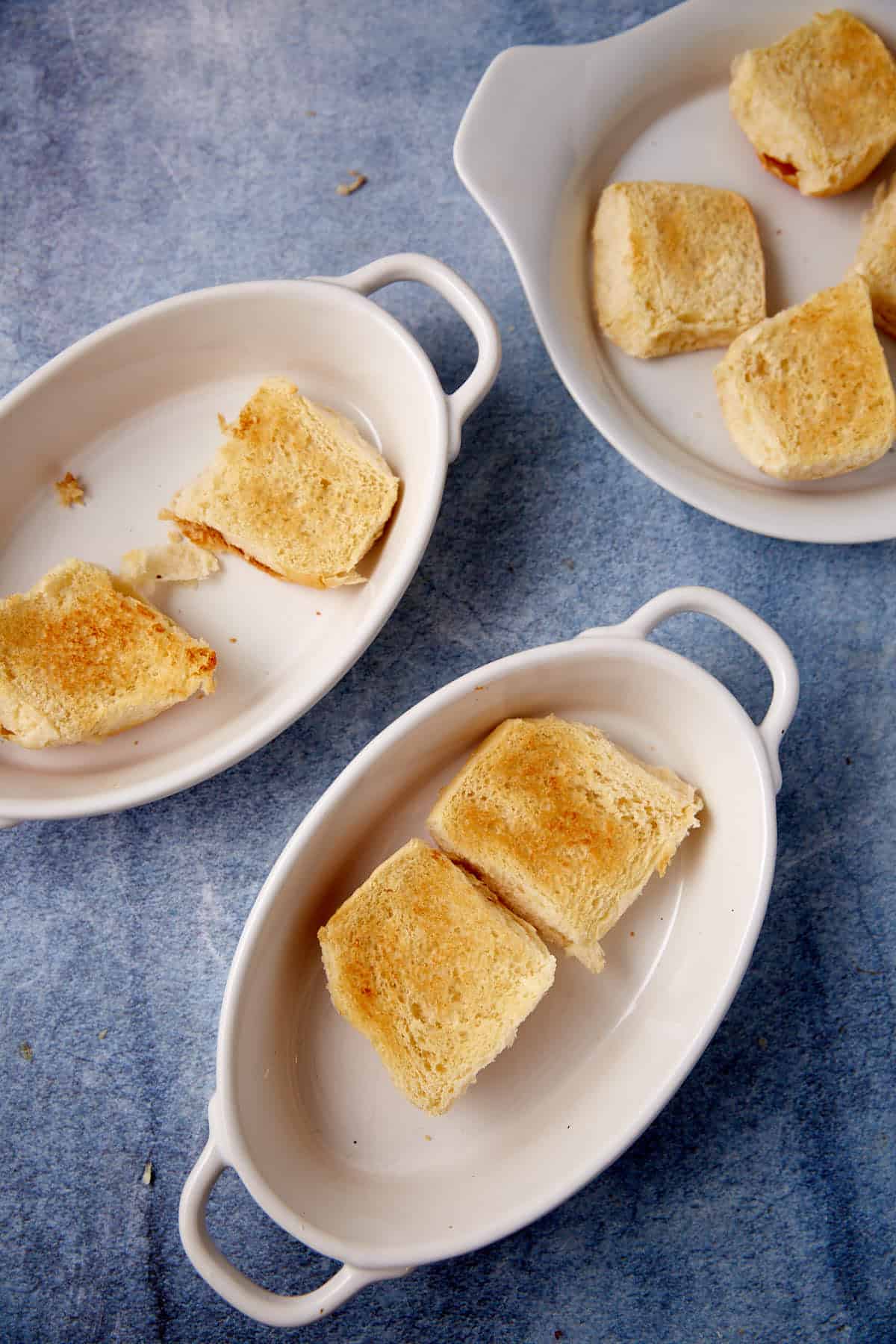 Dinner rolls toasted in a pan.