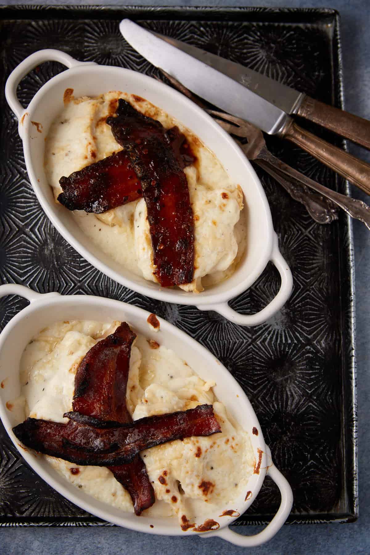 Two ramekins with baked hot browns.