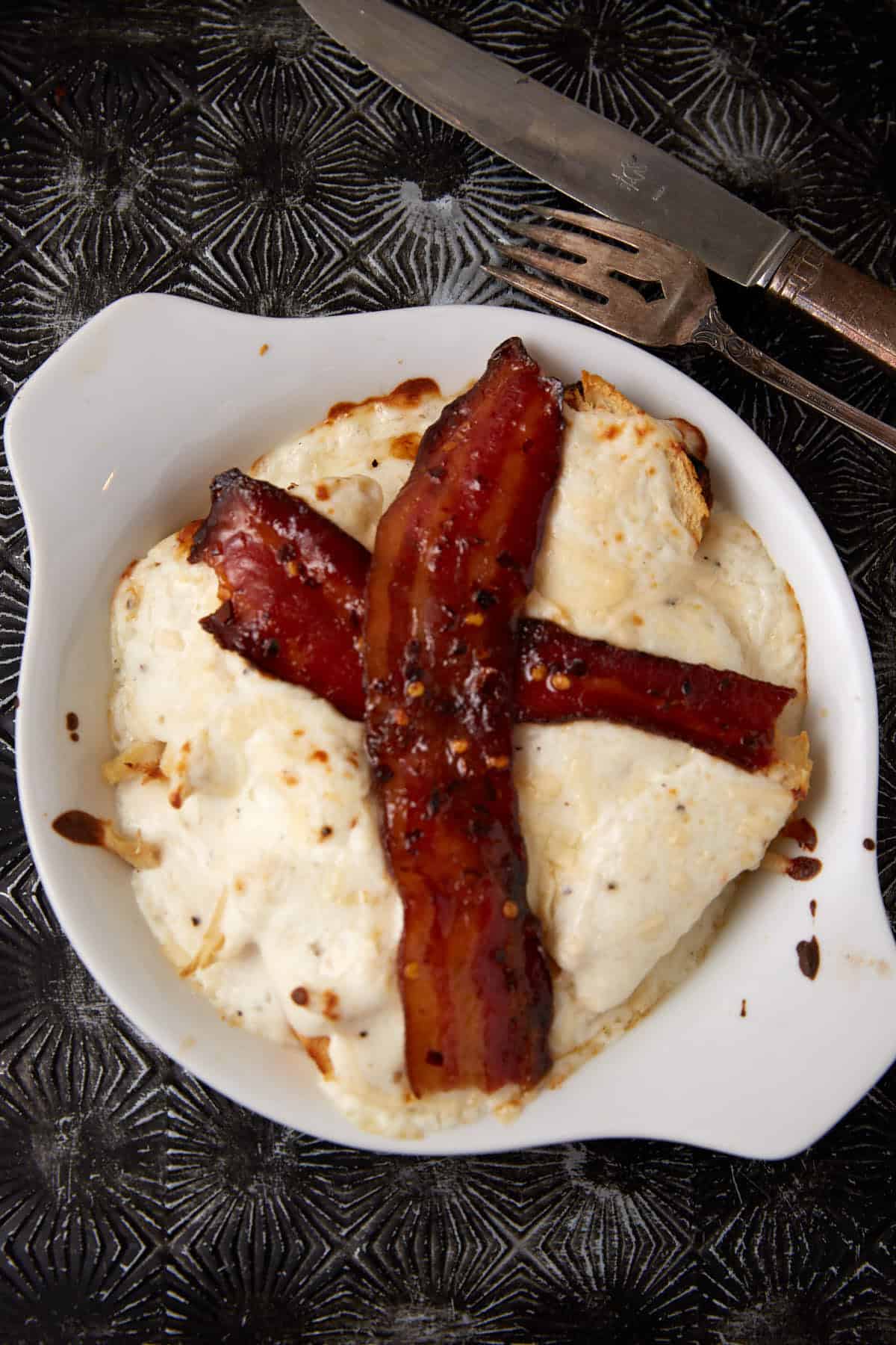 A ramekin with a baked Kentucky hot brown.