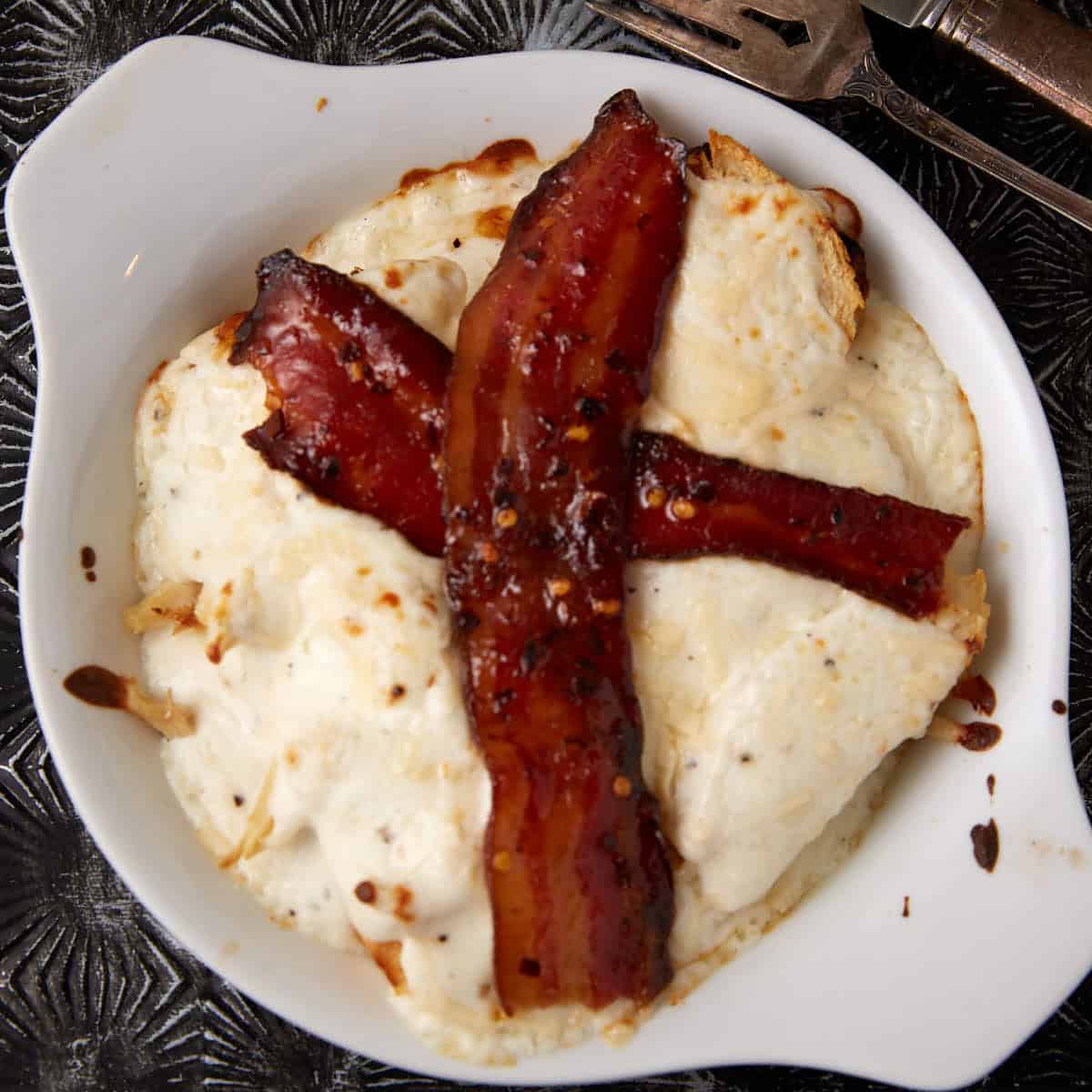 A hot brown with bacon on top.