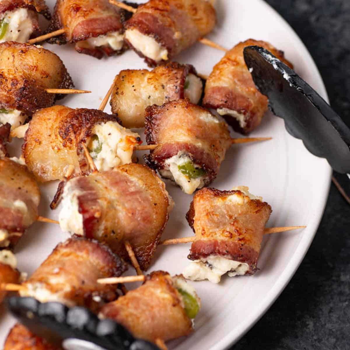 Chicken wrapped in bacon with boursin on a platter.