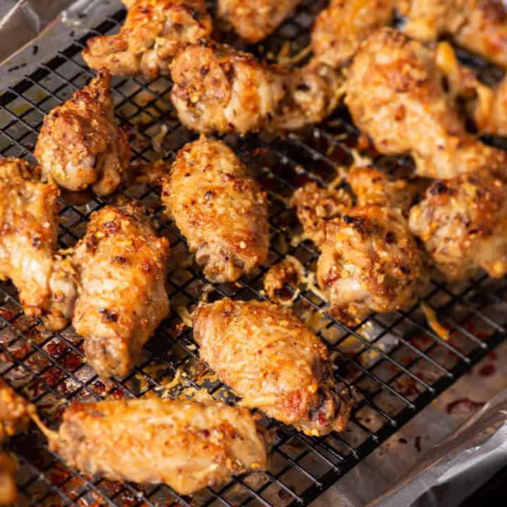 Parmesan chicken wings on a cooling rack.