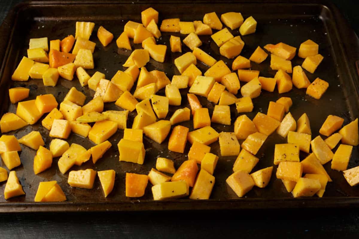 A cutting board of cut squash.