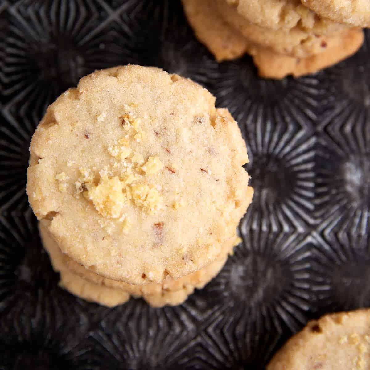 A stack of potato chip cookies with toasted pecans.