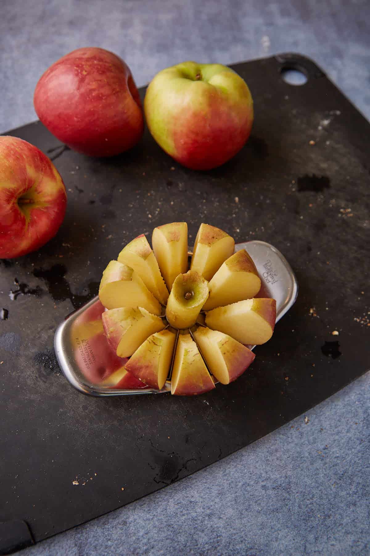An apple being sliced and cored.