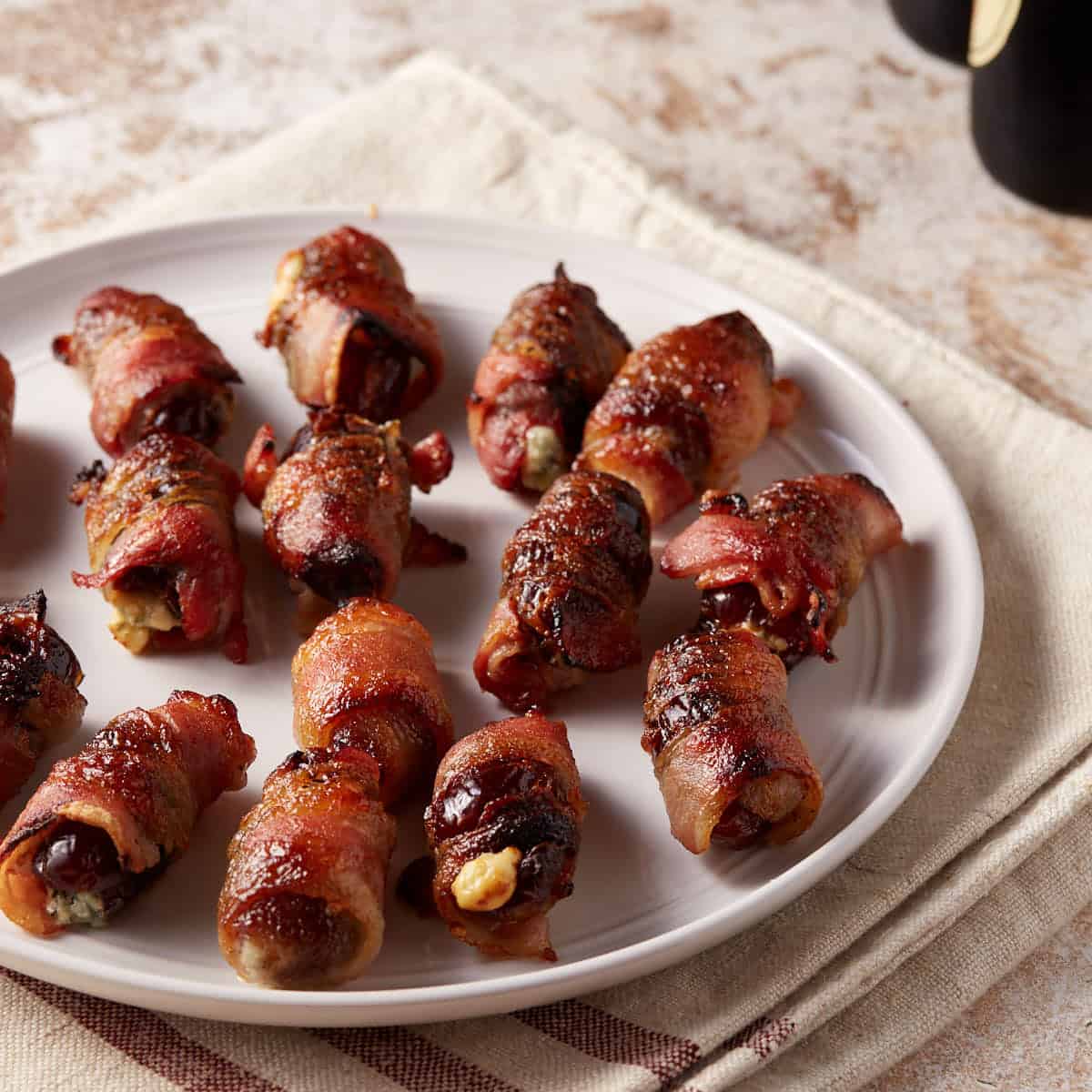 A platter of bacon wrapped stuffed dates.