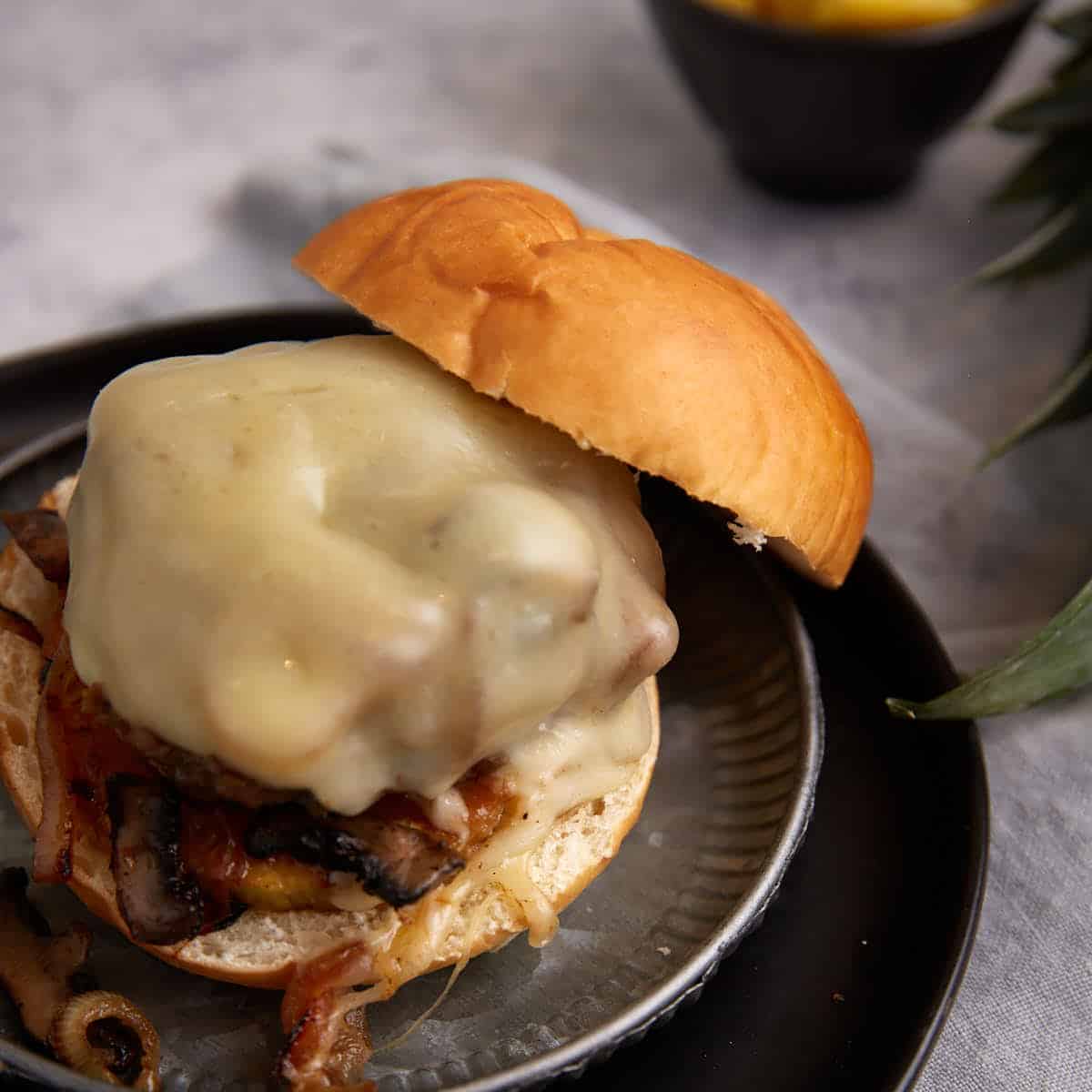 A pineapple burger on a plate with a bun.