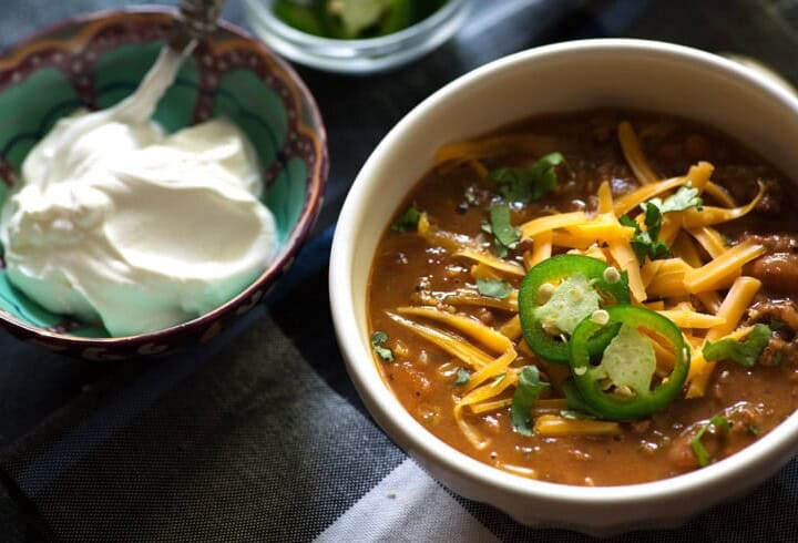 A bowl of Instant Pot chili with sour cream and cheese