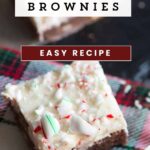 A peppermint brownie with peppermint frosting on a napkin.