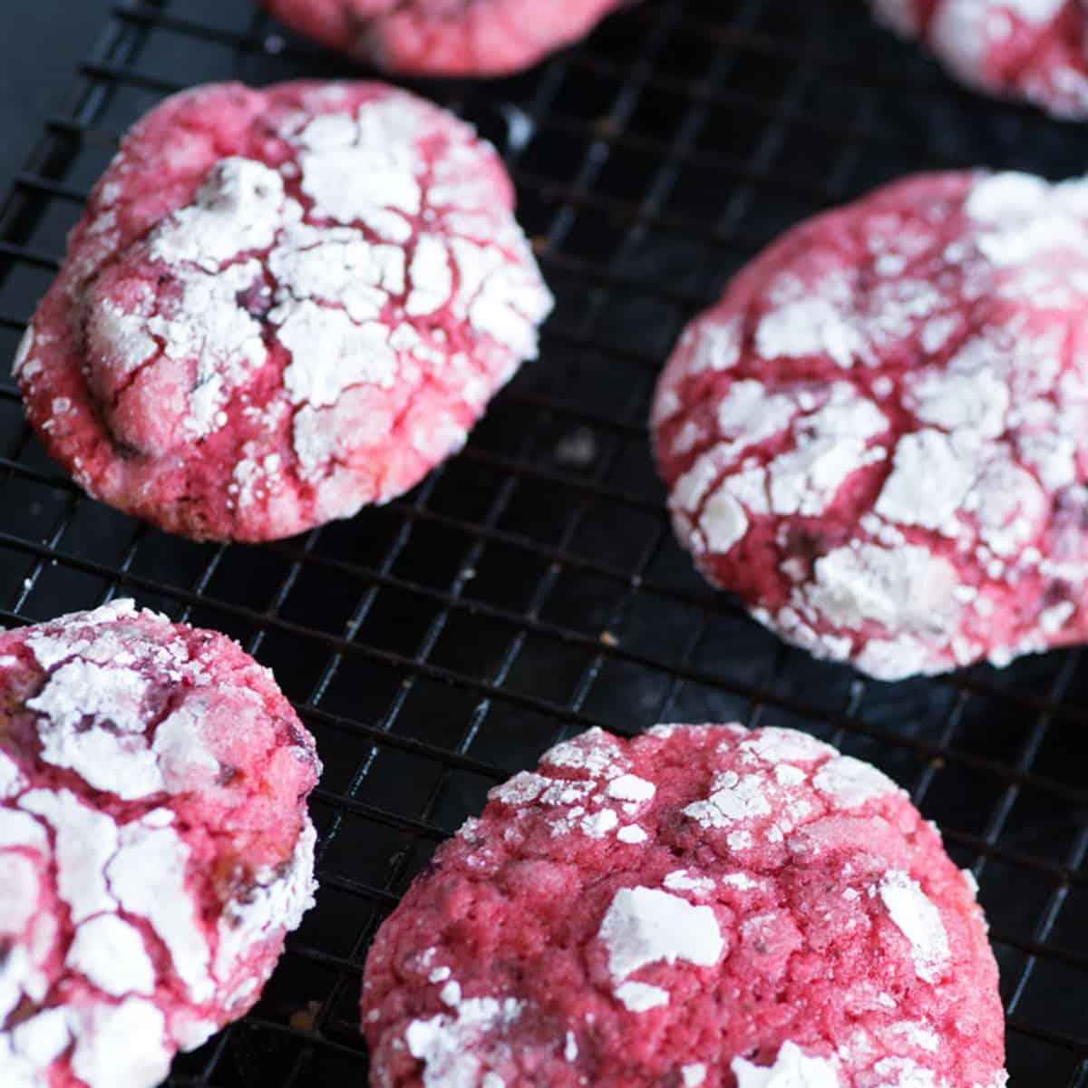 Cherry chocolate cookies on a cooling rack.