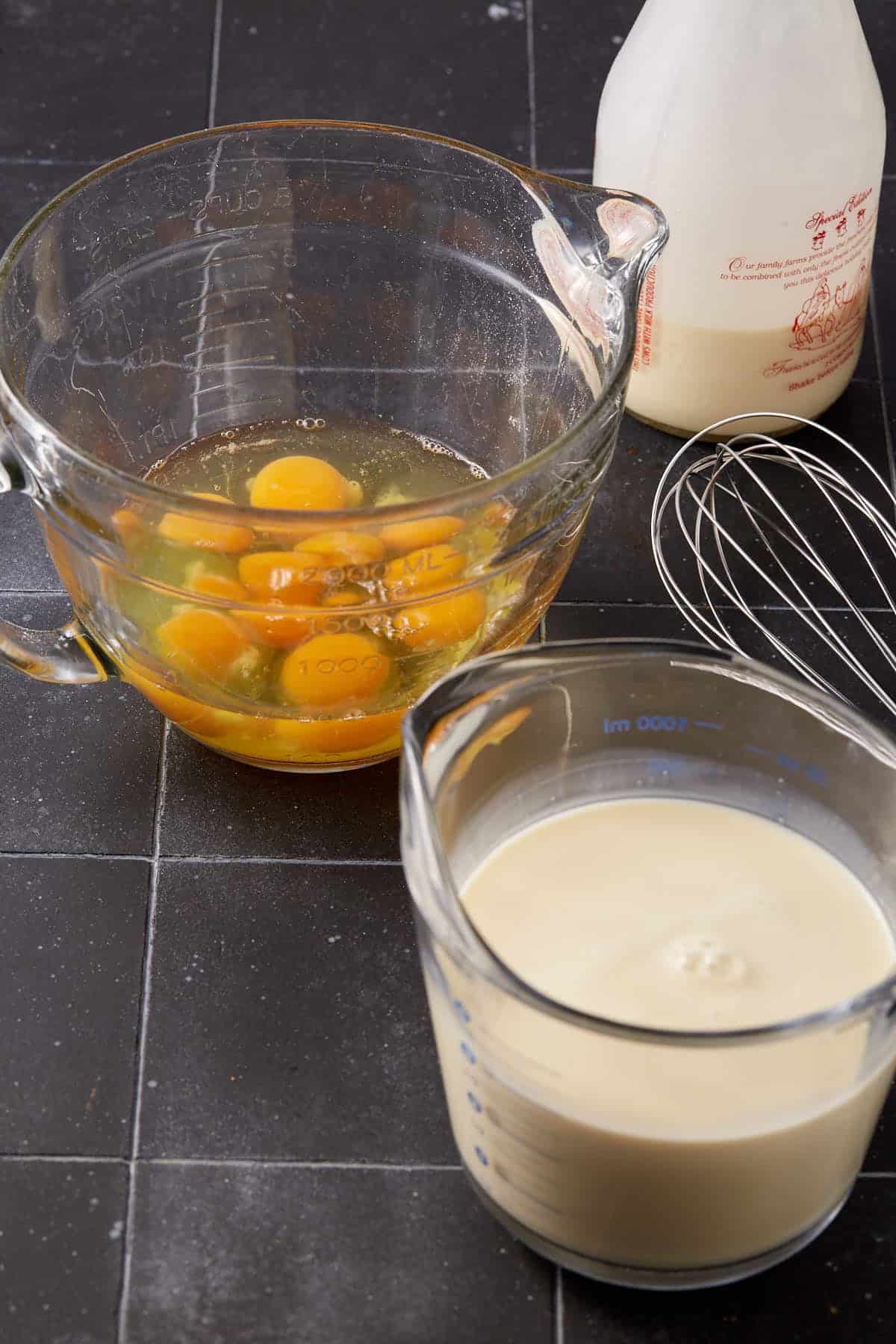 The ingredients in bowls next to a whisk.