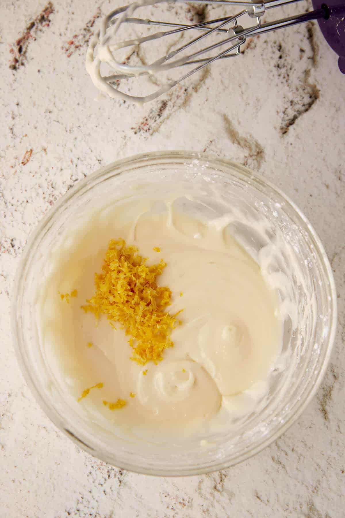 Cream cheese glaze with lemon zest on top.