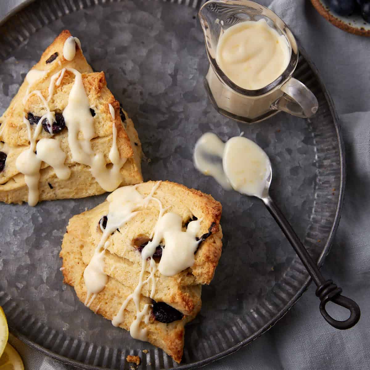 Blueberry scones drizzled with a lemon cream cheese glaze.