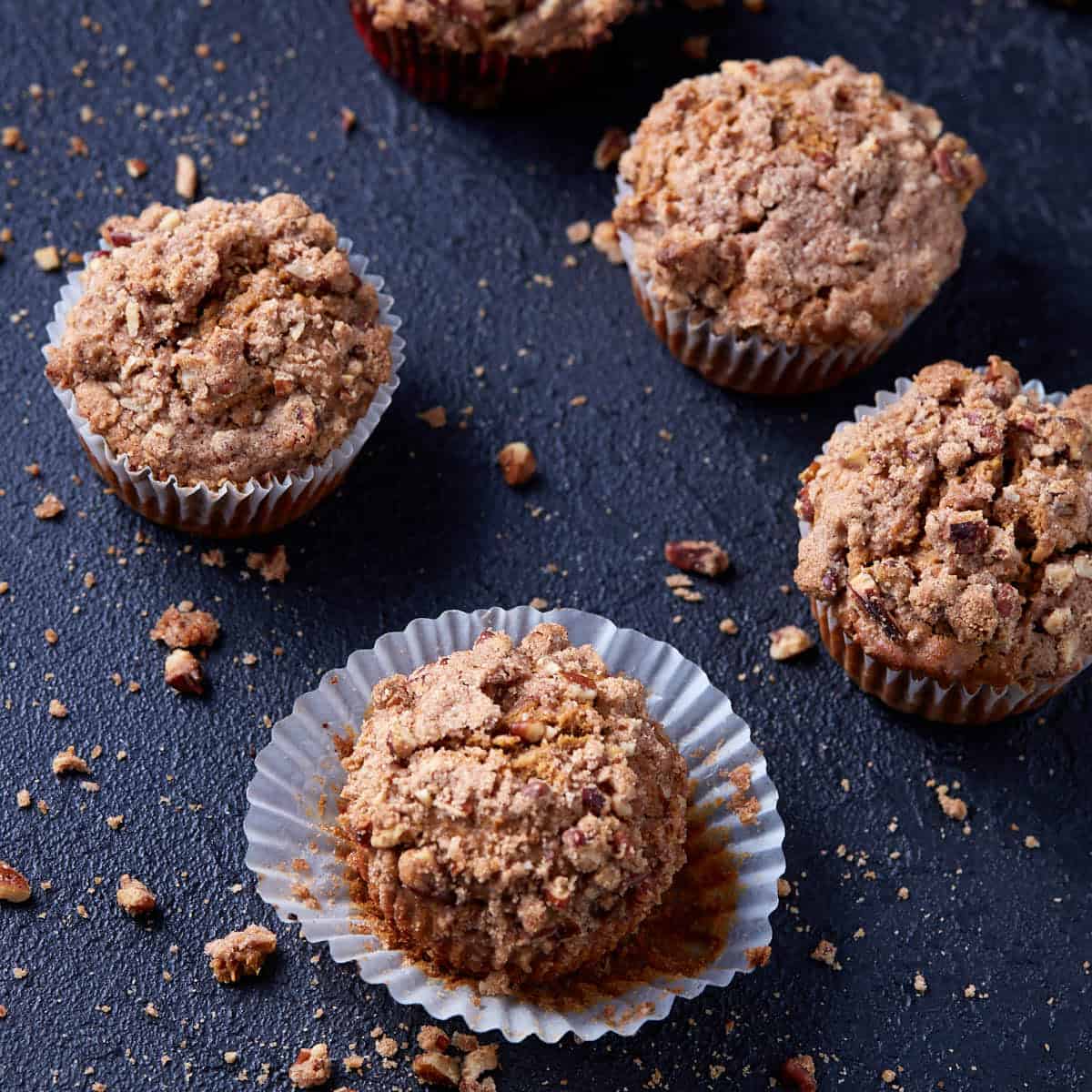 A batch of sweet potato muffins on a black background.