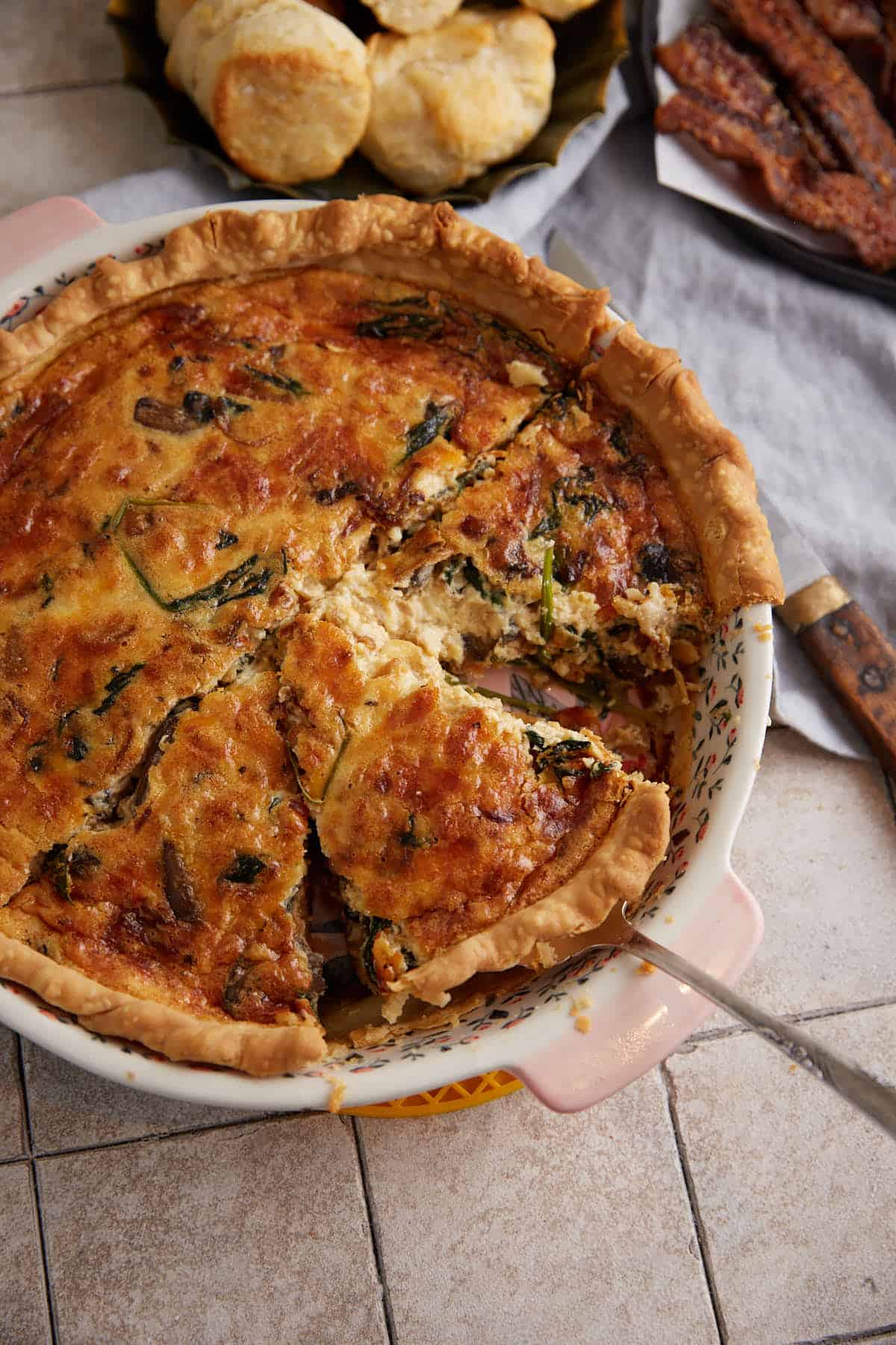 A pie server removing a slice of quiche.