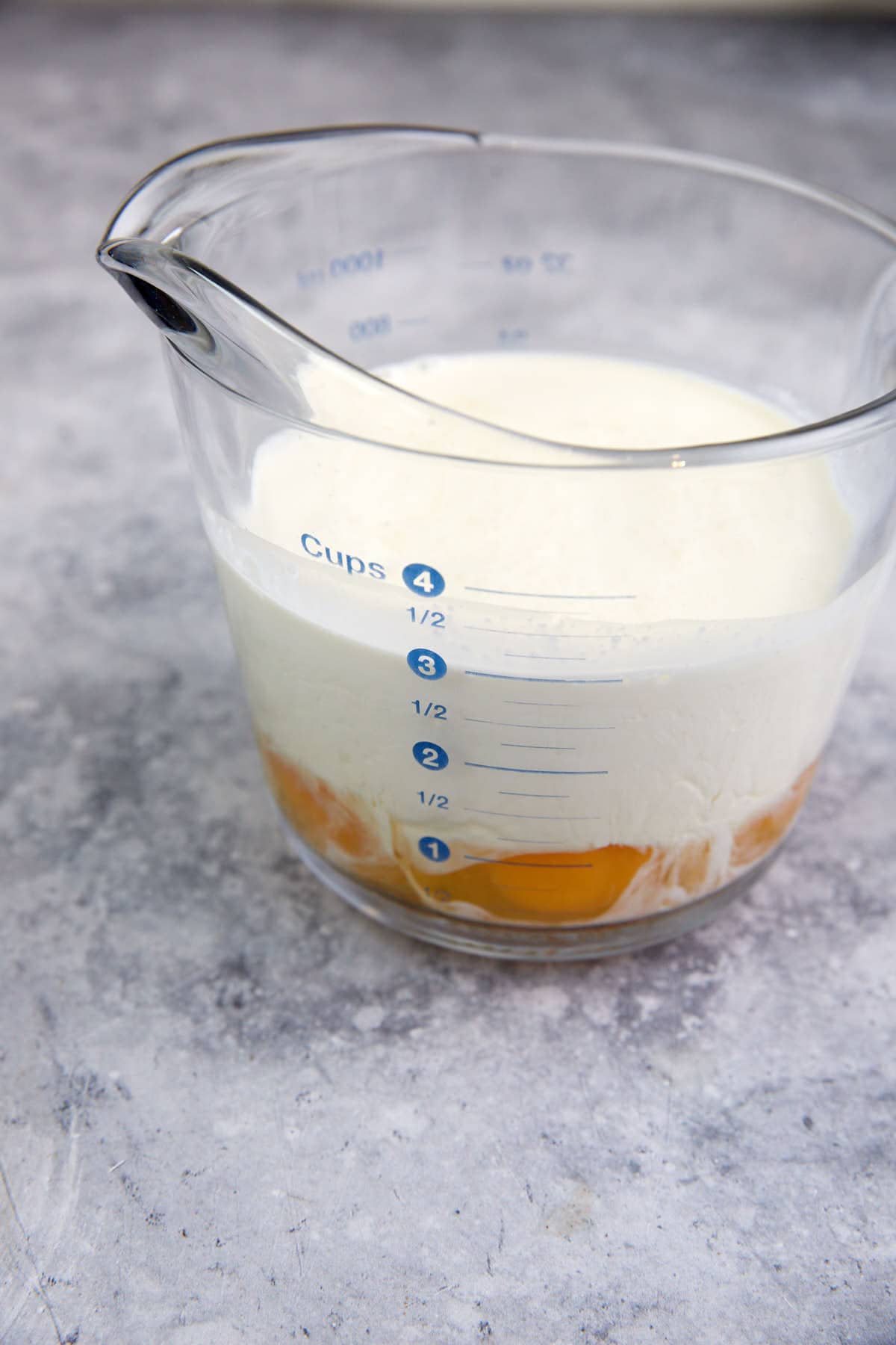 Cream and milk in a measuring bowl.