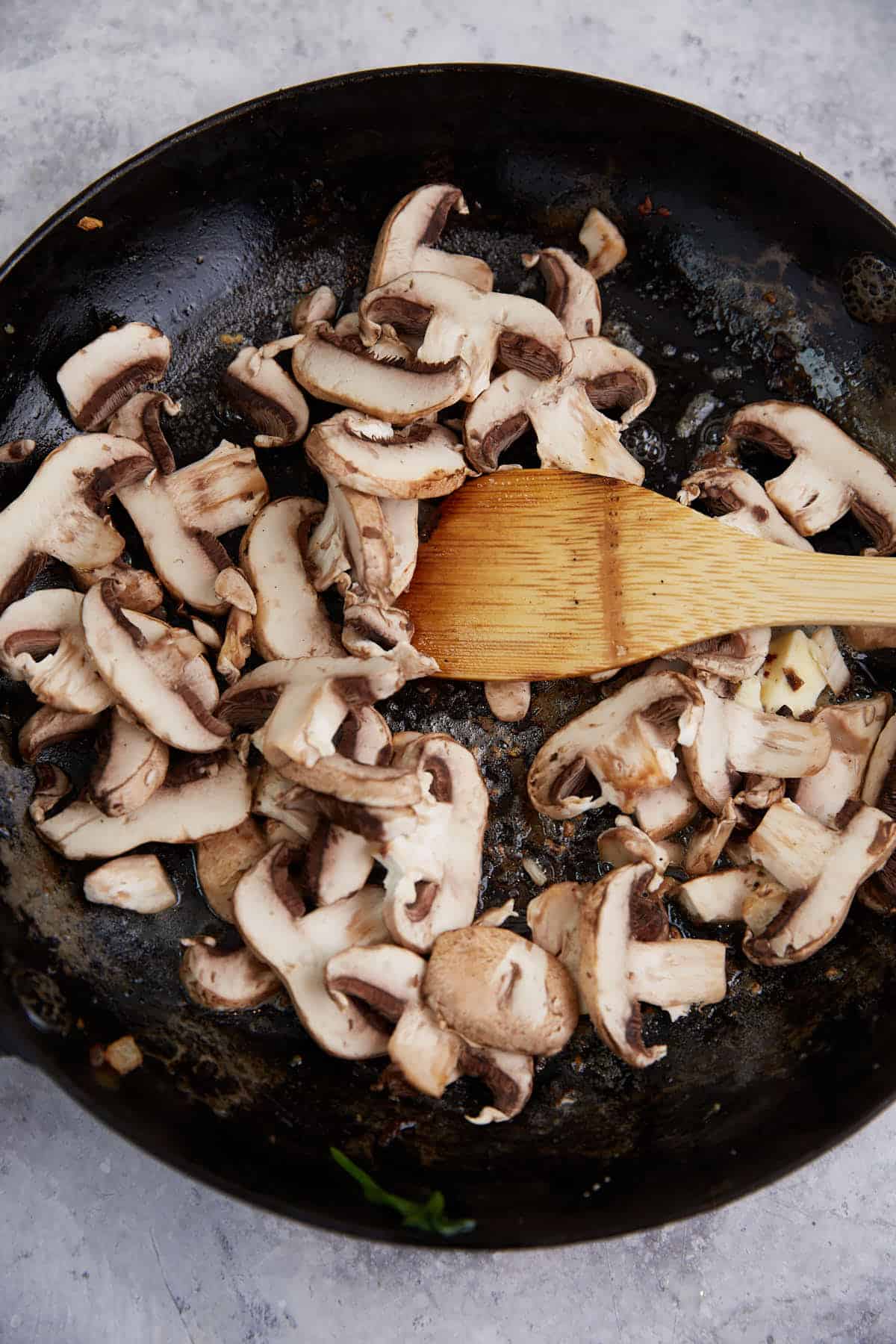 Raw mushrooms in a skillet.