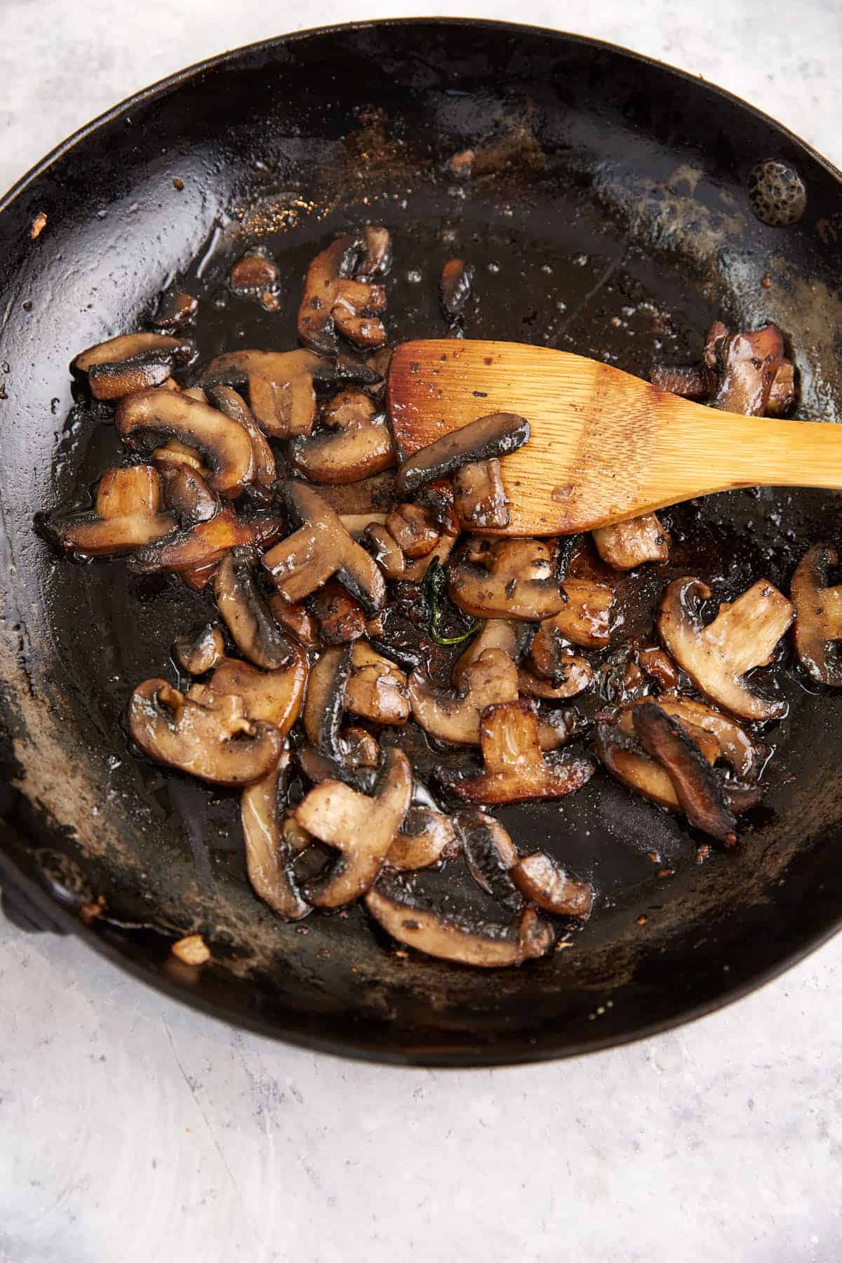 Browned mushrooms in a skillet.