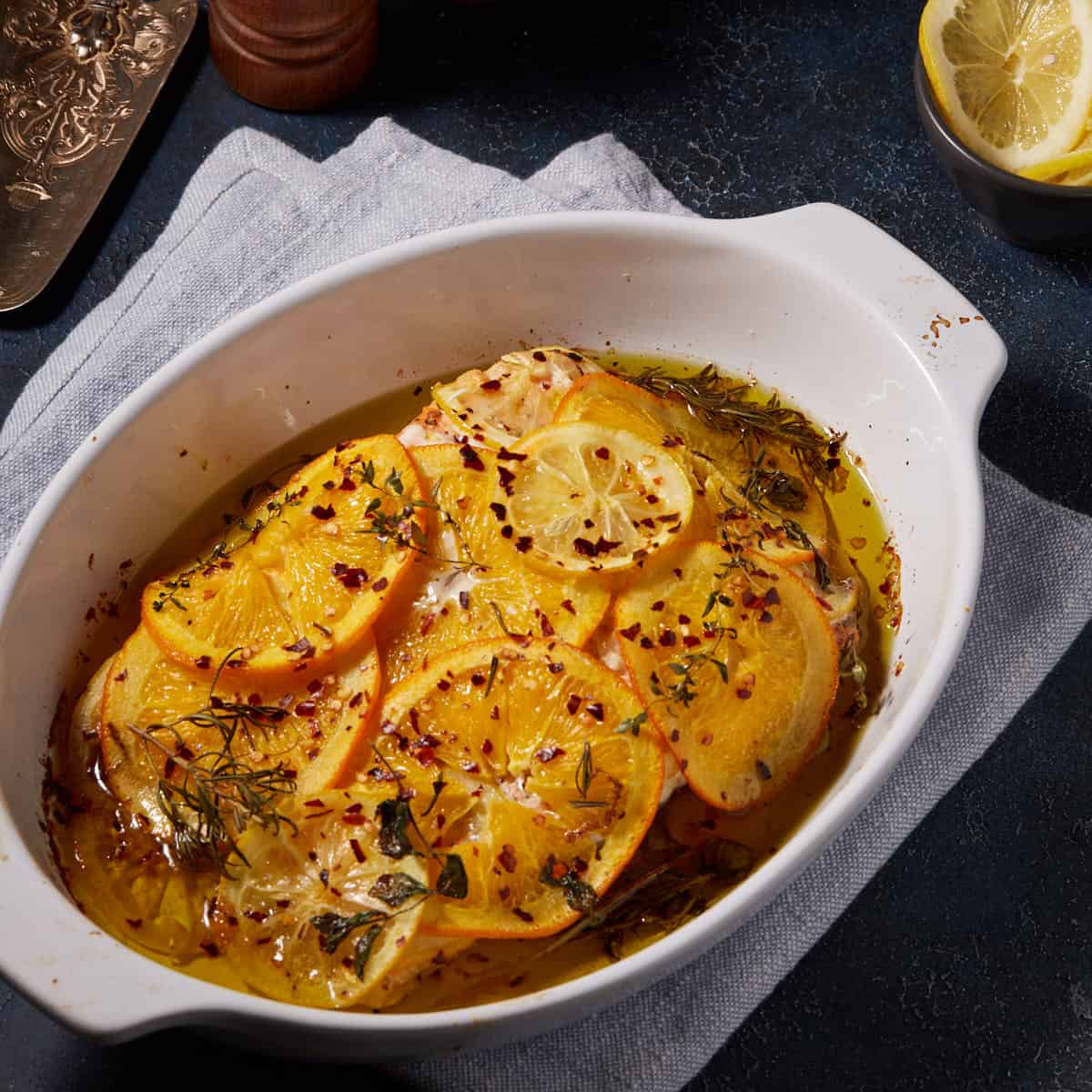 Citrus topped salmon in a baking dish.
